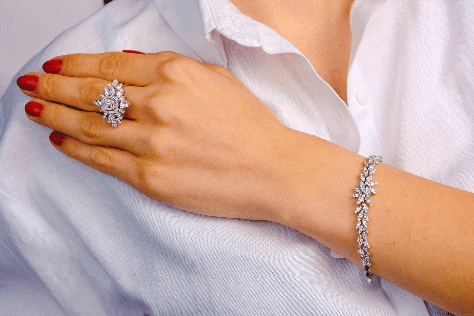 Diamond Jewelers in Dayton, Ohio - woman in white shirt wearing large diamond ring and diamond bracelet