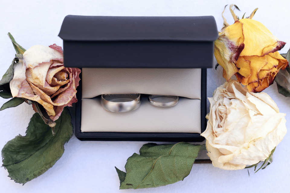 Matching Men's and Ladies Wedding Bands Dayton, OH - matching platinum bands in a box surrounded by roses